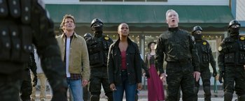 Movie still from “Sonic the Hedgehog 2” (2022), directed by Jeff Fowler – A group of people standing next to each other on the street; Medium shot, Low angle