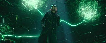 Movie still from “Sonic the Hedgehog 2” (2022), directed by Jeff Fowler – A man dressed in a black costume with a mustache; Medium shot, Low angle