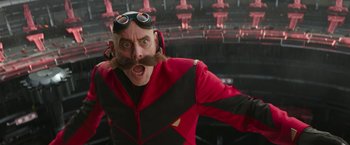 Movie still from “Sonic the Hedgehog 2” (2022), directed by Jeff Fowler – A man with a fake mustache wearing a red and black jacket; Close Up shot, Over the shoulder angle