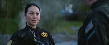 Movie still from “Sonic the Hedgehog 2” (2022), directed by Jeff Fowler – A woman in a black jacket is standing outside; Close Up shot, Over the shoulder angle