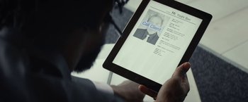 Movie still from “Sorry to Bother You” (2018), directed by Boots Riley – A man is looking at a resume on a tablet; Extreme Close Up shot, High angle