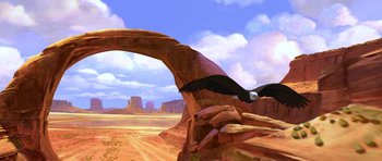Movie still from “Spirit: Stallion of the Cimarron” (2002), directed by Lorna Cook – An image of an eagle flying over the desert; Extreme Wide shot, Low angle