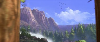 Movie still from “Spirit: Stallion of the Cimarron” (2002), directed by Lorna Cook – An oil painting of a mountain scene with birds flying over the mountains; Extreme Wide shot, Low angle