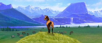 Movie still from “Spirit: Stallion of the Cimarron” (2002), directed by Lorna Cook – A horse standing in a grassy field with mountains in the background; Extreme Wide shot, Low angle