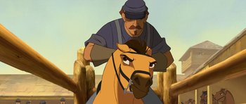 Movie still from “Spirit: Stallion of the Cimarron” (2002), directed by Lorna Cook – An animated picture of a man riding a horse; Close Up shot, Low angle