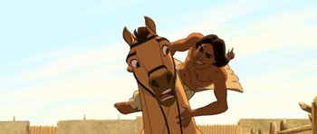 Movie still from “Spirit: Stallion of the Cimarron” (2002), directed by Lorna Cook – An animated man riding on the back of a brown horse; Medium shot, Over the shoulder angle