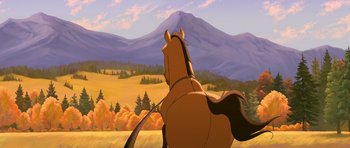 Movie still from “Spirit: Stallion of the Cimarron” (2002), directed by Lorna Cook – A brown horse standing on top of a grass covered field; Wide shot, Low angle
