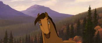 Movie still from “Spirit: Stallion of the Cimarron” (2002), directed by Lorna Cook – A brown horse standing in front of a mountain range; Close Up shot, Low angle