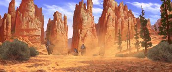 Movie still from “Spirit: Stallion of the Cimarron” (2002), directed by Lorna Cook – An artistic painting of people riding horses in the middle of the desert; Extreme Wide shot, Low angle