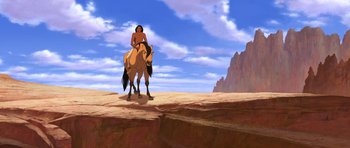 Movie still from “Spirit: Stallion of the Cimarron” (2002), directed by Lorna Cook – An animated scene of a man riding a horse; Wide shot, Overhead angle