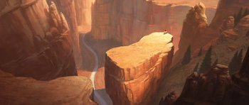 Movie still from “Spirit: Stallion of the Cimarron” (2002), directed by Lorna Cook – A person sitting on top of a rock cliff next to a road; Extreme Wide shot, High angle