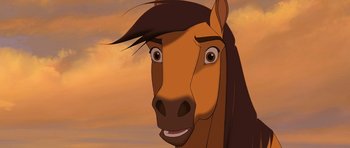 Movie still from “Spirit: Stallion of the Cimarron” (2002), directed by Lorna Cook – A horse with a long mane is looking at the camera; Close Up shot, Low angle