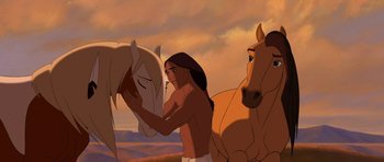 Movie still from “Spirit: Stallion of the Cimarron” (2002), directed by Lorna Cook – A man standing next to two horses in a field; Medium shot, Over the shoulder angle