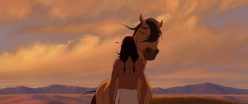 Movie still from “Spirit: Stallion of the Cimarron” (2002), directed by Lorna Cook – An animated picture of a man and a horse; Medium shot, Over the shoulder angle