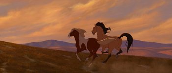 Movie still from “Spirit: Stallion of the Cimarron” (2002), directed by Lorna Cook – A couple of horses are running in a field; Wide shot, Low angle