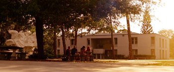 Movie still from “Spring Breakers” (2012), directed by Harmony Korine – A group of people sitting on top of a park bench; Extreme Wide shot, Low angle