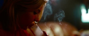 Movie still from “Spring Breakers” (2012), directed by Harmony Korine – A woman is smoking a cigarette and drinking a drink; Close Up shot, Low angle