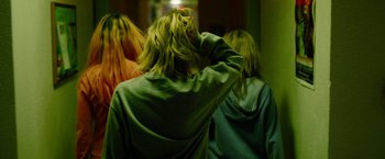 Movie still from “Spring Breakers” (2012), directed by Harmony Korine – A group of people with long blonde hair in a room; Medium shot, Over the shoulder angle