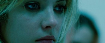 Movie still from “Spring Breakers” (2012), directed by Harmony Korine – A woman's face with blue eyes; Extreme Close Up shot, Low angle