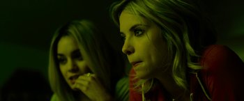 Movie still from “Spring Breakers” (2012), directed by Harmony Korine – Two women sitting next to each other in a dark room; Close Up shot, Over the shoulder angle