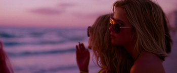 Movie still from “Spring Breakers” (2012), directed by Harmony Korine – Two women are standing on the beach at sunset; Close Up shot, Low angle