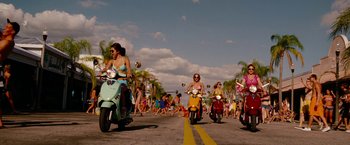 Movie still from “Spring Breakers” (2012), directed by Harmony Korine – A group of women riding scooters down a street; Wide shot, Low angle