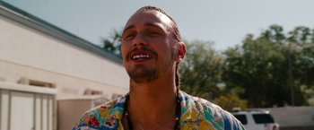 Movie still from “Spring Breakers” (2012), directed by Harmony Korine – A person wearing a shirt; Close Up shot, Over the shoulder angle