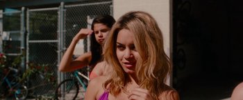 Movie still from “Spring Breakers” (2012), directed by Harmony Korine – Two young women standing next to each other in front of a fence; Close Up shot, Over the shoulder angle
