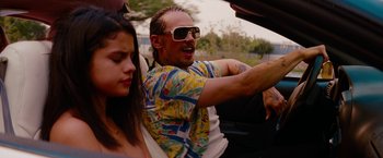 Movie still from “Spring Breakers” (2012), directed by Harmony Korine – A man driving a car while a woman sits in the passenger seat; Close Up shot, Over the shoulder angle