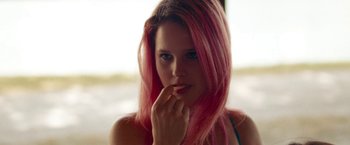 Movie still from “Spring Breakers” (2012), directed by Harmony Korine – A woman with pink hair posing for a picture; Close Up shot, Low angle