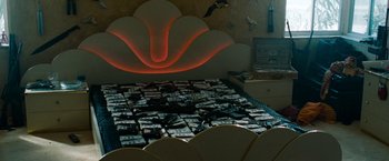 Movie still from “Spring Breakers” (2012), directed by Harmony Korine – A bed that is made up of many pieces of paper; Wide shot, Overhead angle