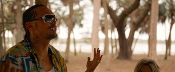 Movie still from “Spring Breakers” (2012), directed by Harmony Korine – A man in a colorful shirt is standing in the woods; Close Up shot, Over the shoulder angle