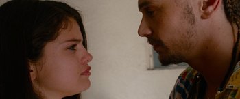 Movie still from “Spring Breakers” (2012), directed by Harmony Korine – A man and a woman face to face in front of a wall; Close Up shot, Low angle