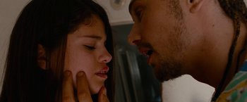 Movie still from “Spring Breakers” (2012), directed by Harmony Korine – A man and a woman face to face in front of a mirror; Close Up shot, Over the shoulder angle