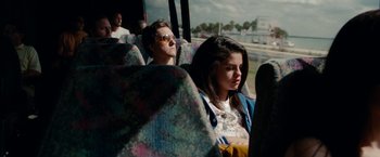 Movie still from “Spring Breakers” (2012), directed by Harmony Korine – A woman sitting next to a man on a bus; Medium shot, Over the shoulder angle