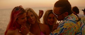 Movie still from “Spring Breakers” (2012), directed by Harmony Korine – A group of people standing next to each other on the beach; Close Up shot, Over the shoulder angle