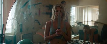 Movie still from “Spring Breakers” (2012), directed by Harmony Korine – A woman holding a knife in her hands; Medium shot, Over the shoulder angle