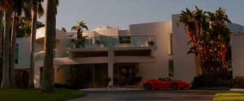 Movie still from “Spring Breakers” (2012), directed by Harmony Korine – A red sports car parked in front of a white building; Extreme Wide shot, Low angle