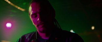 Movie still from “Spring Breakers” (2012), directed by Harmony Korine – A man with long dreadlocks is looking down at his face; Close Up shot, Low angle