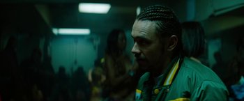 Movie still from “Spring Breakers” (2012), directed by Harmony Korine – A man in a green jacket and a woman in a green dress; Close Up shot, Over the shoulder angle