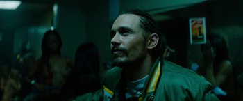 Movie still from “Spring Breakers” (2012), directed by Harmony Korine – A person wearing a green jacket; Close Up shot, Low angle