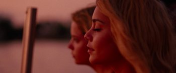 Movie still from “Spring Breakers” (2012), directed by Harmony Korine – Two women with their eyes closed in front of a pink background; Close Up shot, Low angle