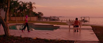 Movie still from “Spring Breakers” (2012), directed by Harmony Korine – A swimming pool with a view of the water; Extreme Wide shot, Over the shoulder angle
