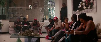 Movie still from “Spring Breakers” (2012), directed by Harmony Korine – A group of people sitting around a living room together; Wide shot, High angle