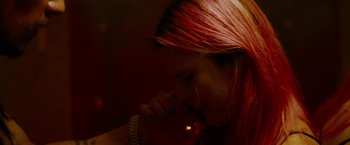 Movie still from “Spring Breakers” (2012), directed by Harmony Korine – A woman with pink hair is smoking a cigarette; Close Up shot, Overhead angle