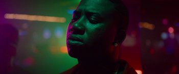 Movie still from “Spring Breakers” (2012), directed by Harmony Korine – A person with a green light in the background; Close Up shot, Low angle