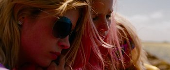 Movie still from “Spring Breakers” (2012), directed by Harmony Korine – Two women with pink hair and sunglasses looking at the camera; Close Up shot, Low angle