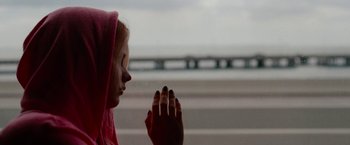 Movie still from “Spring Breakers” (2012), directed by Harmony Korine – A woman with her hands in prayer position; Close Up shot, Over the shoulder angle