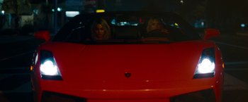Movie still from “Spring Breakers” (2012), directed by Harmony Korine – Two women in a red sports car at night; Wide shot, High angle