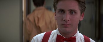 Movie still from “St. Elmo's Fire” (1985), directed by Joel Schumacher – A person wearing a red bow tie; Close Up shot, Low angle